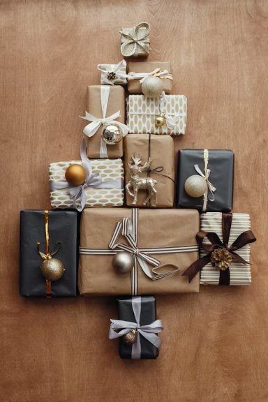 Christmas presents wrapped in matching browns, whites and golds and contrasting ribbons.