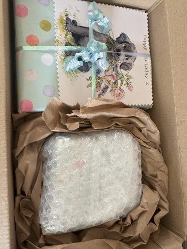 Present wrapped in pale blue paper with homemade gift tag attached