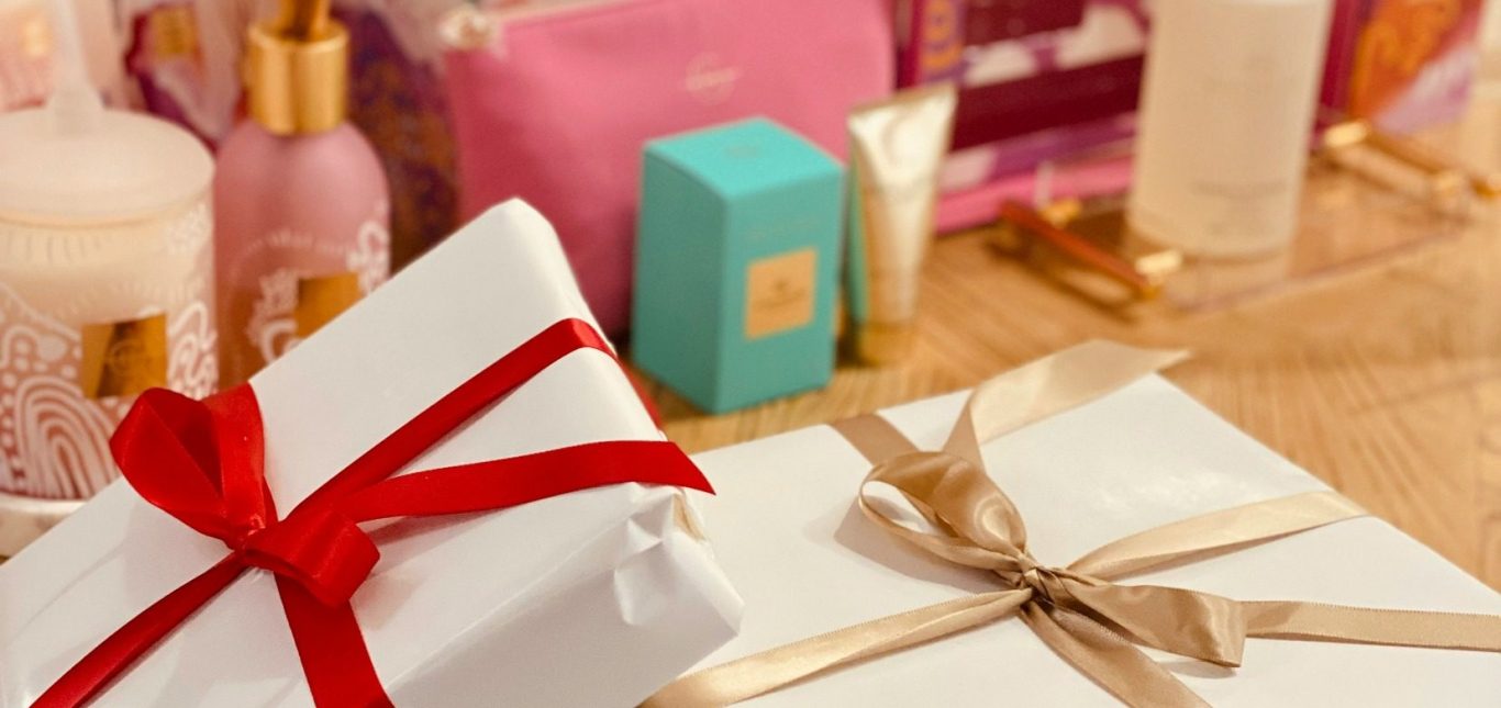 Two presents wrapped in plain white satin paper with a red bow and a gold bow. Two presents wrapped in plain white satin paper with a red bow and a gold bow, perfect for a romantic or birthday gift.