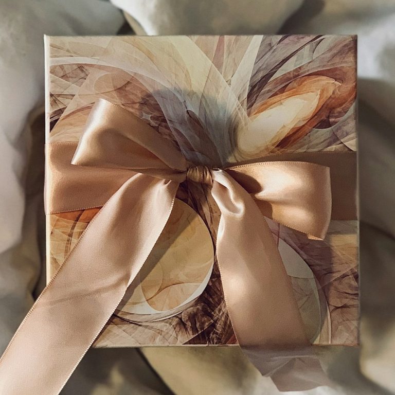 Cream, Gold & Brown gift box tied with a muted apricot satin bow.